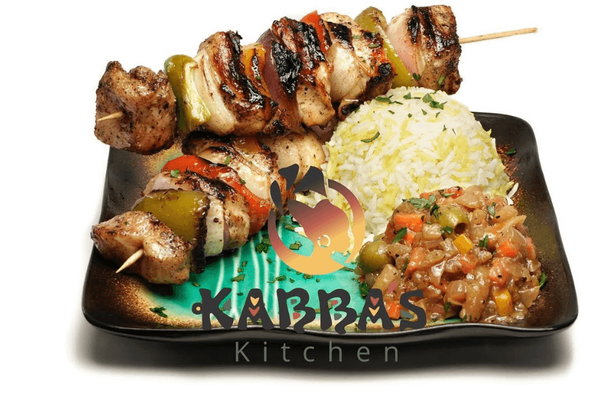 Brochette kebab skewers grilled with charred edges, plated with fries and side salad